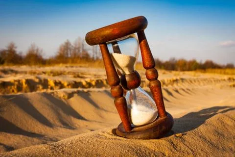 Hourglass in sands Stock Photos