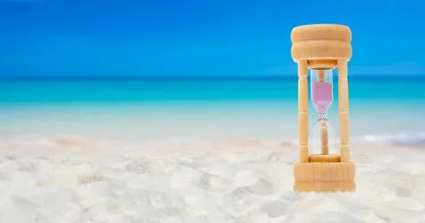 Hourglass set on a white sand background sea background, time concept Stock-Fotos