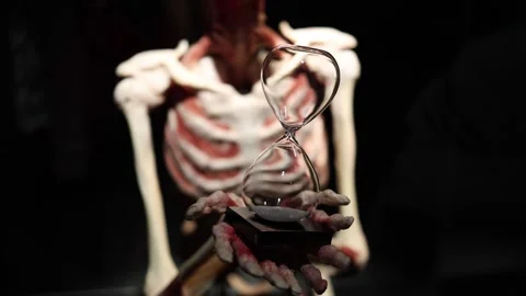 Hourglass in skeleton hands time concept Stock Footage 330679619