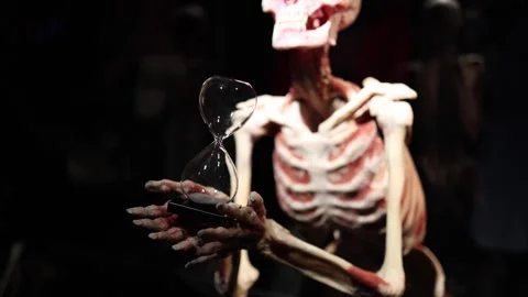 Hourglass in skeleton hands time concept Stock Footage 330679802