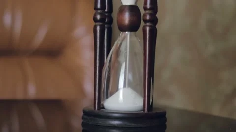 Hourglass standing on a table. Stock-Footage 52926342