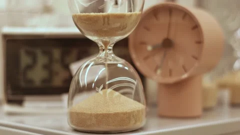 Hourglass on the table with different clocks on the background, with a dial Stock Footage 236514072