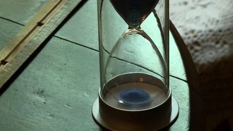 Hourglass on table Stock Footage 74767618