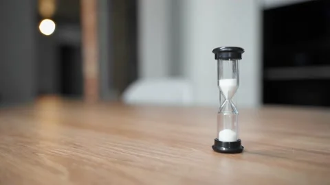 The hourglass is on the table in the kitchen. The sand is poured to the end Stock Footage 151970960