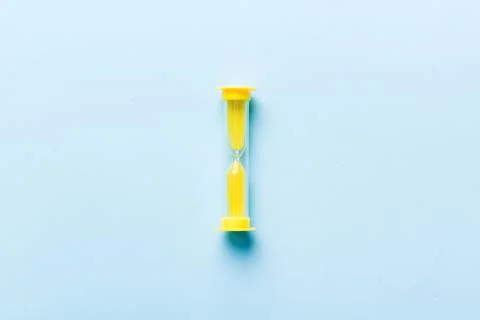 Hourglass on the table, sand clock as time passing concept for business deadl Stock Photos