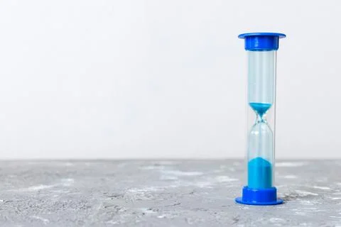 Hourglass on the table, sand clock as time passing concept for business deadl Stock Photos