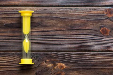 Hourglass on the table, sand clock as time passing concept for business deadl 写真素材