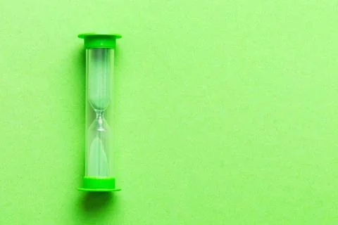 Hourglass on the table, sand clock as time passing concept for business deadl Stock Photos