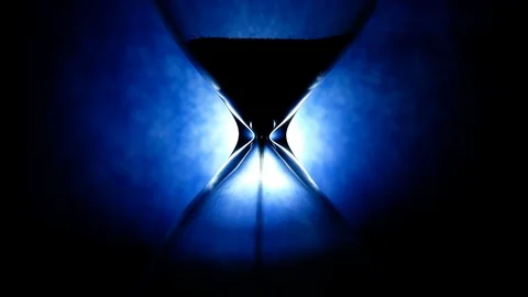 Hourglass time flow on blue background, time pass concept 4k Stock Footage 119410631