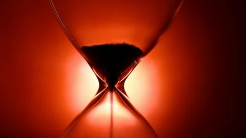 Hourglass time flow on red background, time pass concept 4k Stock Footage 119359362