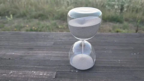 Hourglass timer with sand flowing, symbolizing passage of time and moments Stock Footage 340631402