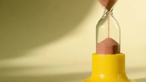 Hourglass on a yellow background Stock Footage 161112651