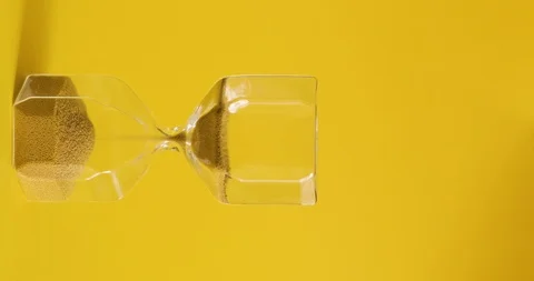 Hourglass on yellow background. Time is up. Time and transience concept. Stock Footage 105305025
