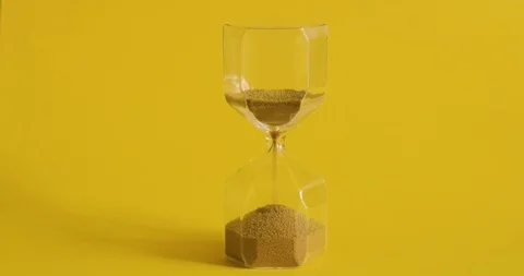 Hourglass on yellow background. Time is up. Time and transience concept. Stock Footage 105305512