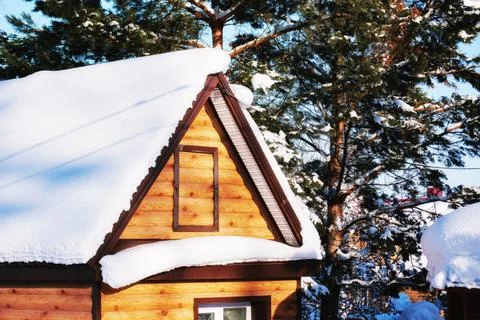 House in alps between the trees under the big snowdrift of white fresh snow Stock Photos