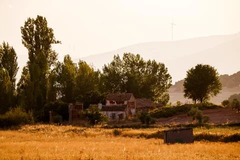 House and fields with windmills in the background Stock Photos
