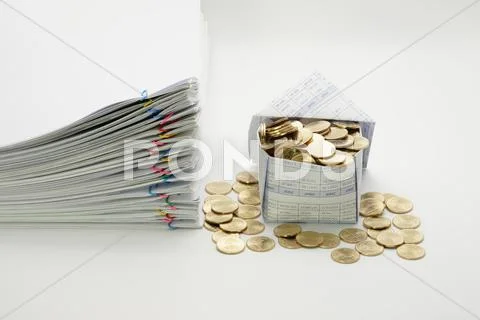 House and gold coins with pile overload document Stock Photos