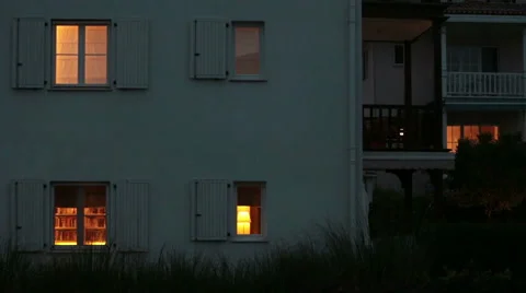 House and it's windows while light bulbs are on inside Stock Footage 51673247