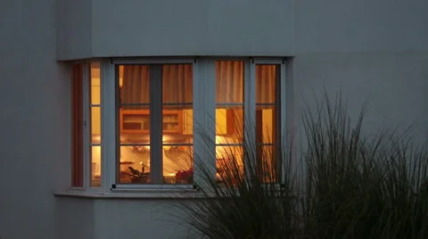 House and it's windows while light bulbs are on inside Stock Footage 51673547