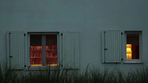 House and it's windows while light bulbs are on inside Stock Footage 51673858