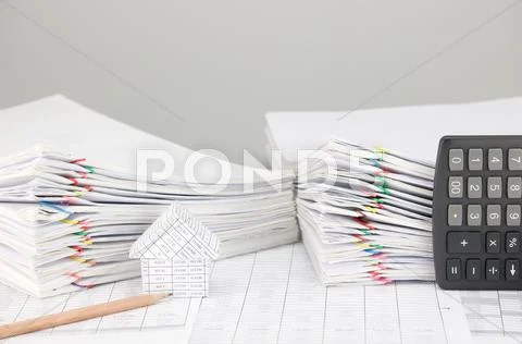 House and pencil have overload document and calculator as background Stock Photos