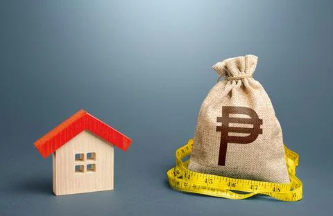 House and a philippine peso money bag. Property real estate valuation. Buil.. Stock Photos