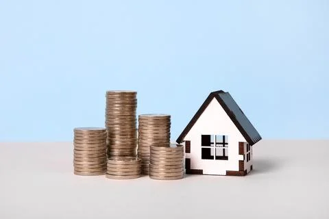 House and stack of coins Stock Photos
