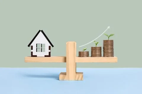 House and stack of coins Stock Photos