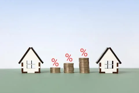 House and stack of coins Stock Photos