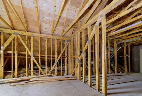 House attic under construction interior inside a frame walls beam built home  Stock Photos