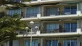 House balconies with awnings swaying in wind, real estate in sunny resort city 4k or 4k+ Resolution