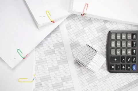 House with blur calculator and stack paperwork on finance account Stock Photos
