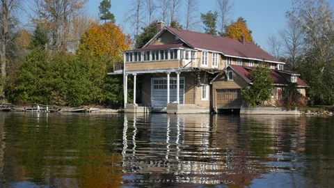 A house with a boat garage built right by the water Stock Footage 165016472