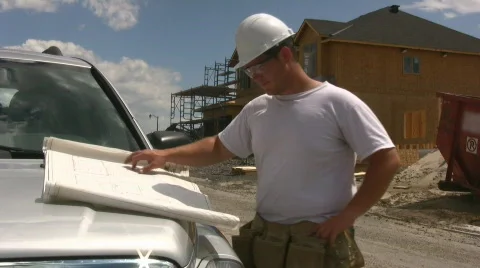 House Builder Looking At Plans On The Hood Of His Truck Stock Footage 481259