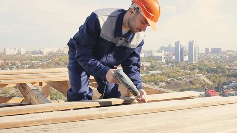 House-builder on the roof Stock Footage 70420554