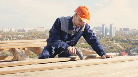 House-builder on the roof Stock Footage 76987427