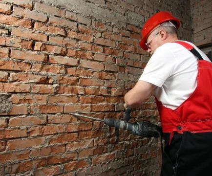House-builder in uniform working with a plugger Stock Photos