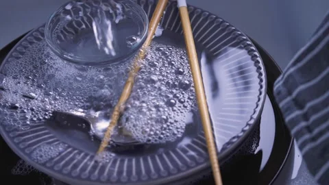 House Cleaning routine. Water streaming on dishes in kitchen sink. Hand washing  Stock Footage 143019055