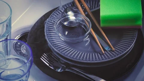 House Cleaning routine. Water streaming on dishes in kitchen sink. Hand washing  Stock Footage 143242155