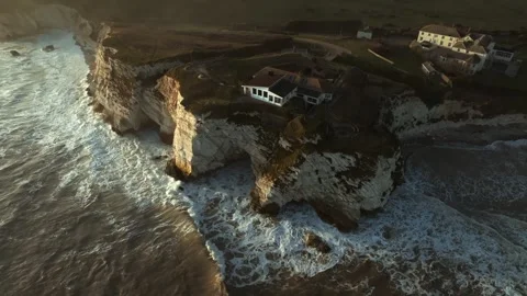 A house is on a cliff overlooking the ocean Stock Footage 303710162
