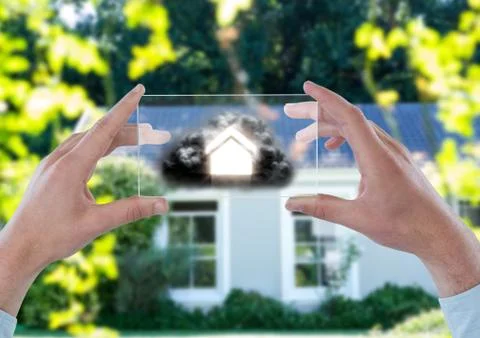 House with cloud on futuristic device in front of a house 写真素材