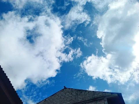 House with clouds background Stock Photos