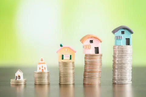 House with coins stack on bokeh background Foto stock