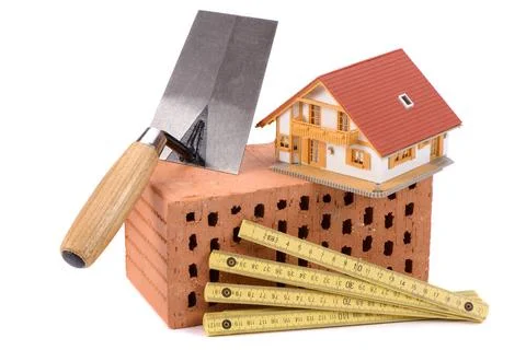 House construction with brick, tools, plan and model house house construct... Stock Photos