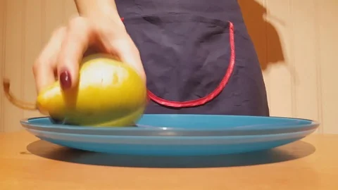 House cook serving four delicious ripe green pears on plate on wooden table Stock Footage 82323538
