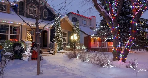 House decorated with Christmas lights on a winters night. Stock Footage