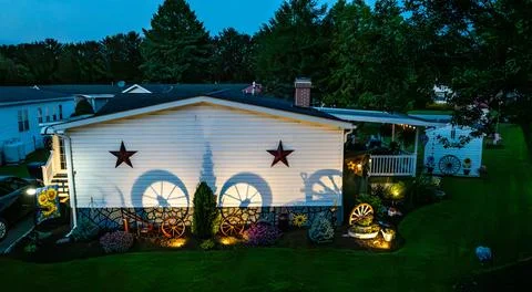 House With Decorative Elements and Shadows at Night in a Suburban Area Foto stock