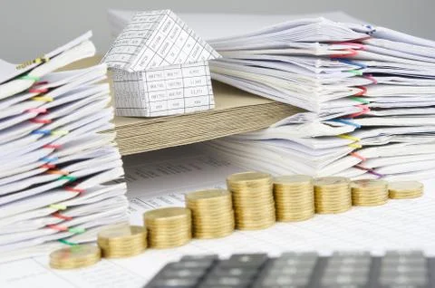 House on envelope between paperwork have blur calculator as foreground Stock Photos