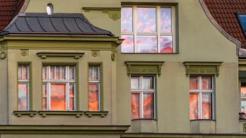 House Facade, with Reflection of Fiery Sunset in the Windows Stock Photos