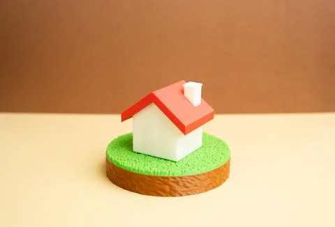 House figure on a plot of land. Real estate, property rights. Buying and se.. 写真素材